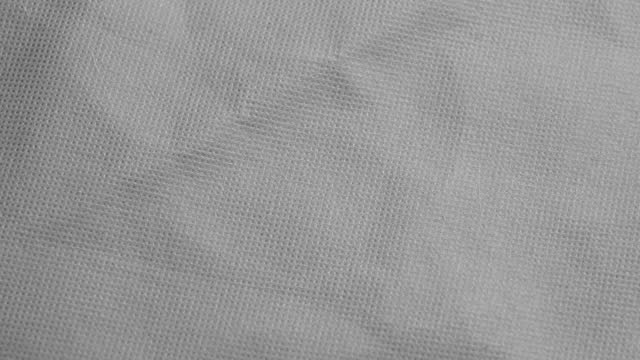 Crumpled grey fabric texture abstract background close up. Rotation