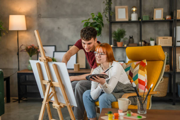 istock Two students are painting on canvas at home 2084518287
