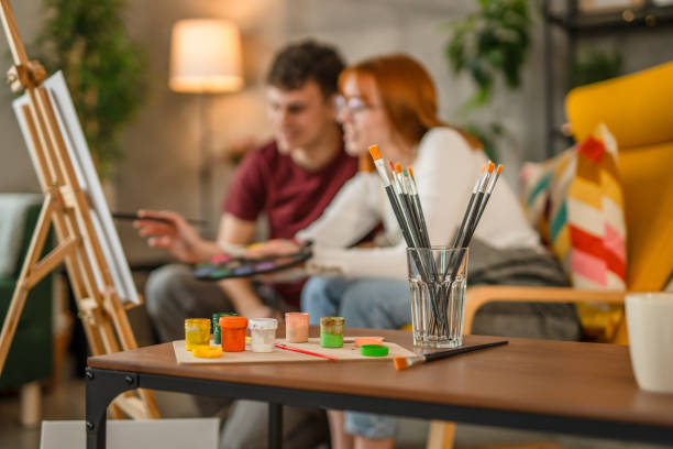 istock Two students are painting on canvas at home 2084519360