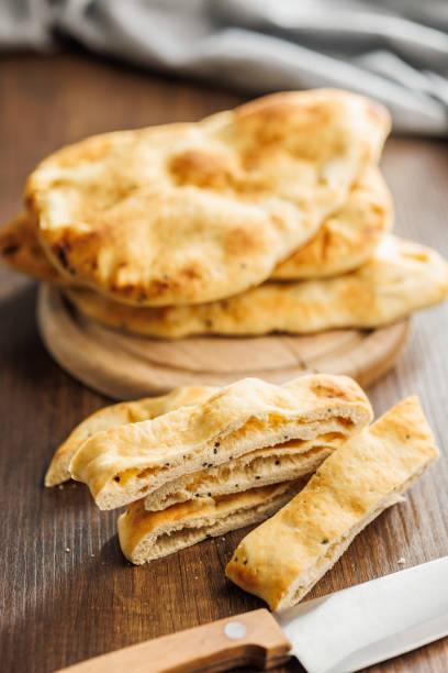 istock Freshly Baked Naan Bread on wooden table 2084524627