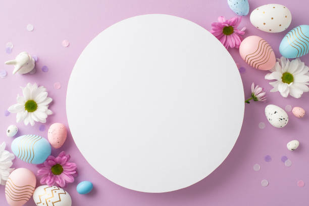istock Trendy Easter tableau captured from top view, presenting eggs, ceramic bunny, daisies, and confetti on a soft violet base, leaving circular space for custom messages or promos 2084539194