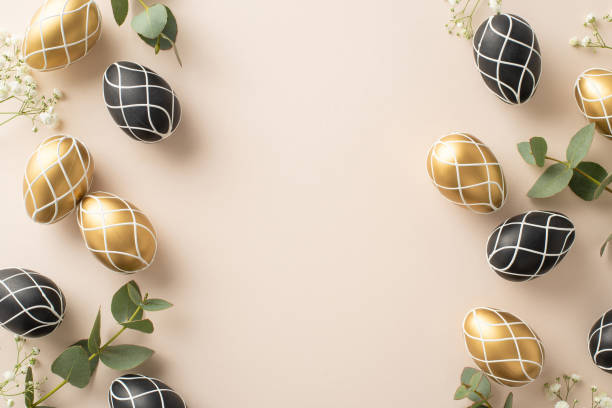 istock Easter luxury design: Top view featuring lavish black and gold eggs, pristine eucalyptus branches, delicate gypsophila flowers, all set against pale beige canvas, with space for text or advertisement 2084539908