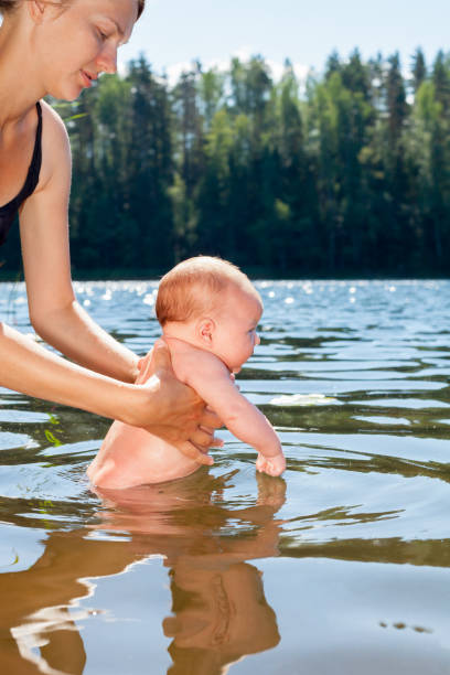 istock Mother baths infant outdoor 2084570351