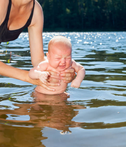 istock Mother baths infant outdoor 2084571894