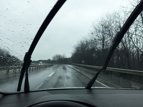 Windshield wipers in motion while driving on a rainy day