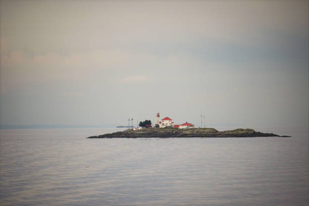 View of Mouro Island (Isla de Mouro), a small uninhabited island with a 19th century lighthouse in the Bay of Biscay, located off the Magdalena Peninsula in the city of Santander, Cantabria, northern Spain
