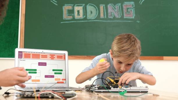 istock Caucasian boy fixing main board by using screwdriver at stem lesson. Pedagogy. 2084607098