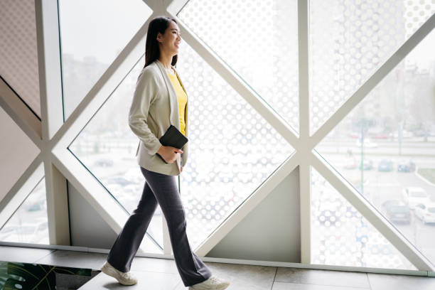 istock Modern office and young woman working in a bank 2084616972