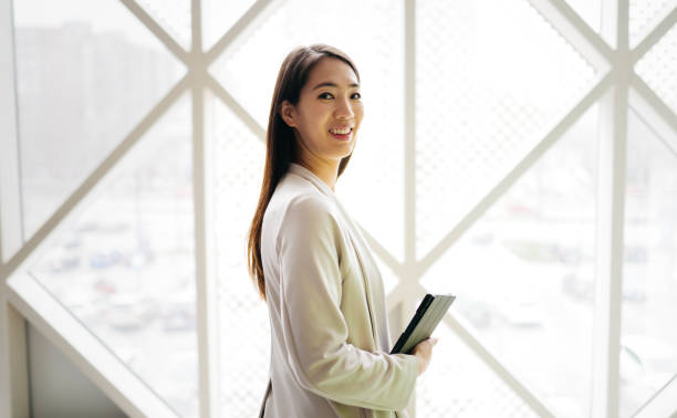 istock Asian businesswoman in her modern office 2084617520