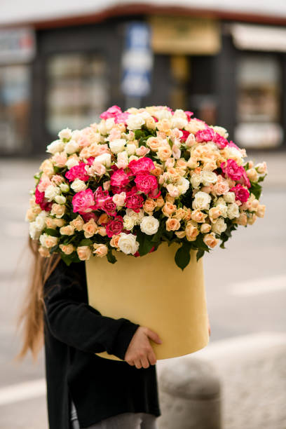 istock Huge bouquet of multi-colored roses in a round box 2084621191