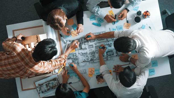 istock Top view of project manager or engineer writing at blueprint. Alimentation. 2084621712