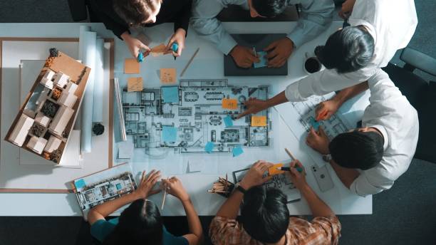 istock Top view of project manager or engineer writing at blueprint. Alimentation. 2084624347