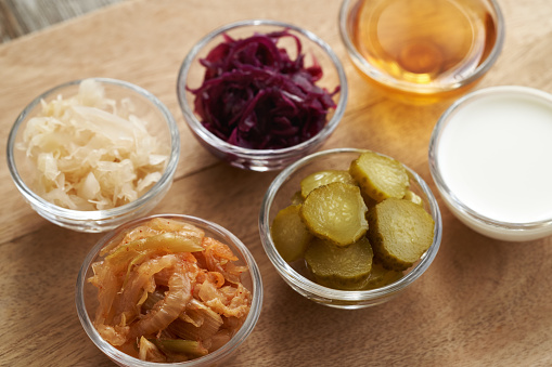 Fermented foods and vegetables - kimchi, white and purple sauerkraut, apple cider vinegar, gherkins and kefir