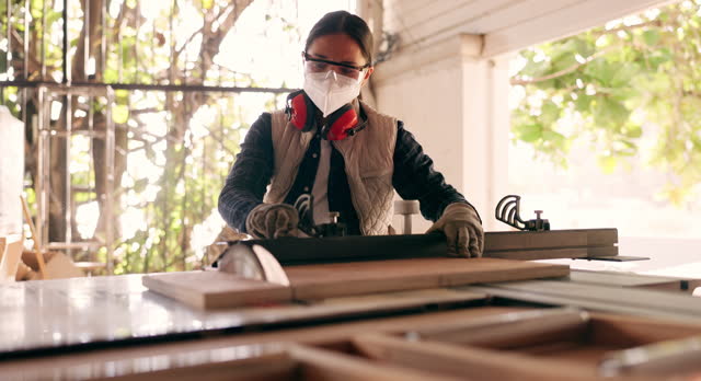 Wood, tools and saw with woman in workshop for furniture, manufacturing and renovation. Production, carpenter and design with person and equipment in home garage for remodeling, board or handyman