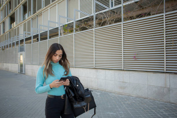 istock Latina woman using cell phone 2084658982