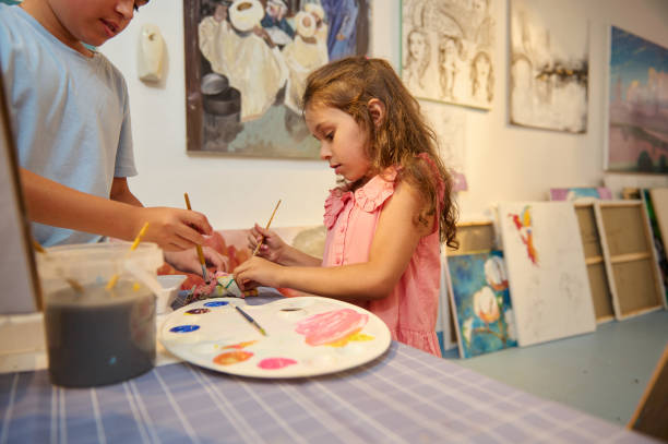 istock Adorable kids learn drawing in fine art gallery or creative workshop. Painting. Education. Elementary age school 2084665716