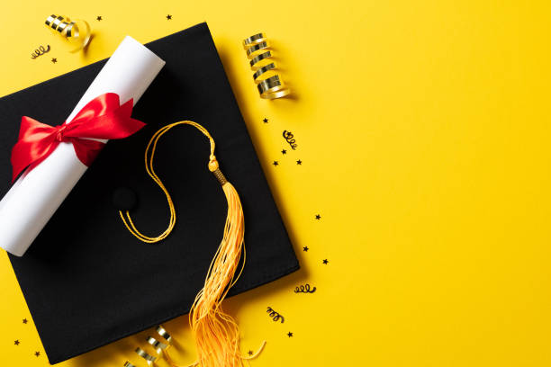 istock Flat lay composition with graduation hat and diploma on yellow background 2084670898