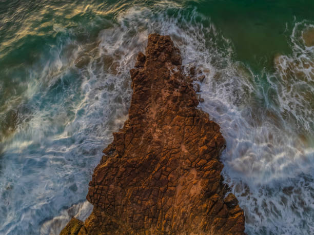 Top down sunrise over the sea and rock platform