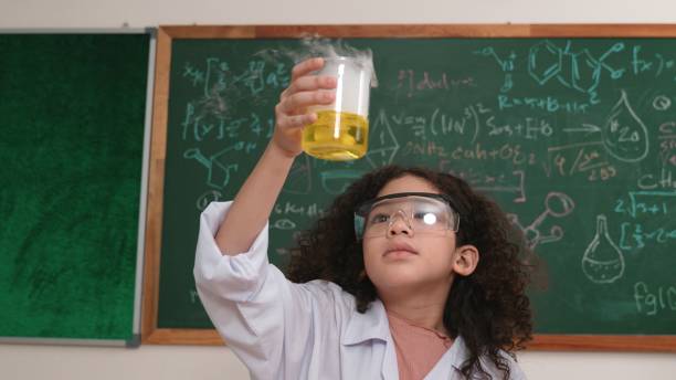 istock Attractive american student hold beaker and inspect colored solution. Pedagogy. 2084692203
