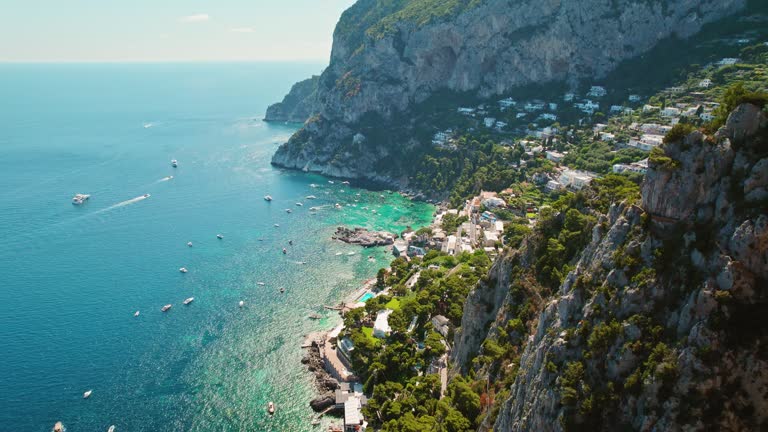 Capri Seaside Splendor with Huge Cliffs on Ocean. Majestic coastal nature landscape with sea and rocks. Aerial view of summer Italy.