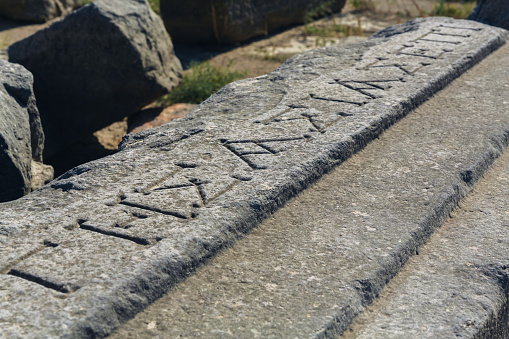 Ancient gravestone on Cape Cod depicting a smiling winged angel  and the words \