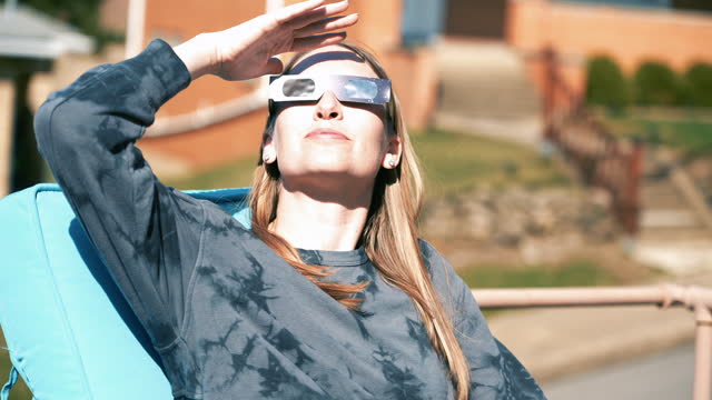 Young Woman Looks at Solar Eclipse