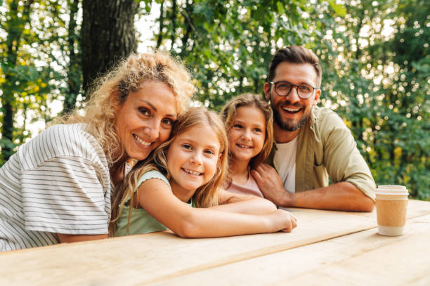 istock Loving family is spending day in nature playing a fun board game. 2084812547