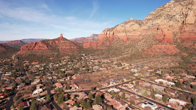 Sedona, Arizona USA. Aerial View of Residential Community Under Red Rock Hills and Hiking Trails, Drone Shot