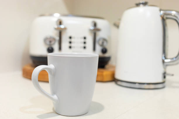 Luxury still life of a coffee cup, toaster and kettle in a kitchen