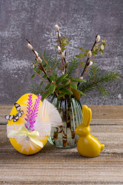 istock Wooden table with Easter bunny, egg and bunch of willow. 2084836144
