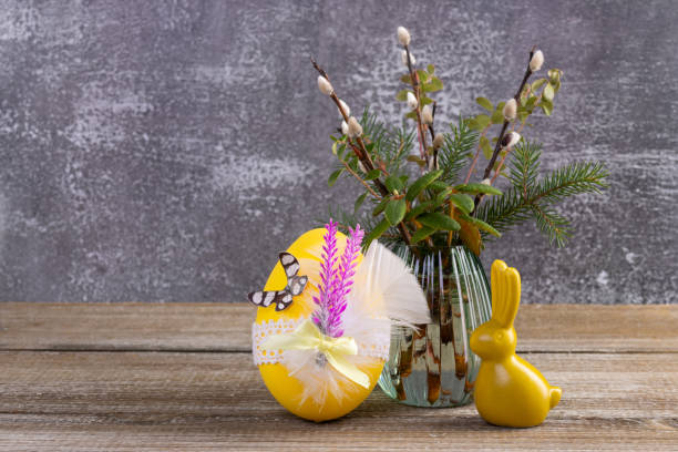 istock Wooden table with Easter bunny, egg and bunch of willow. 2084836147