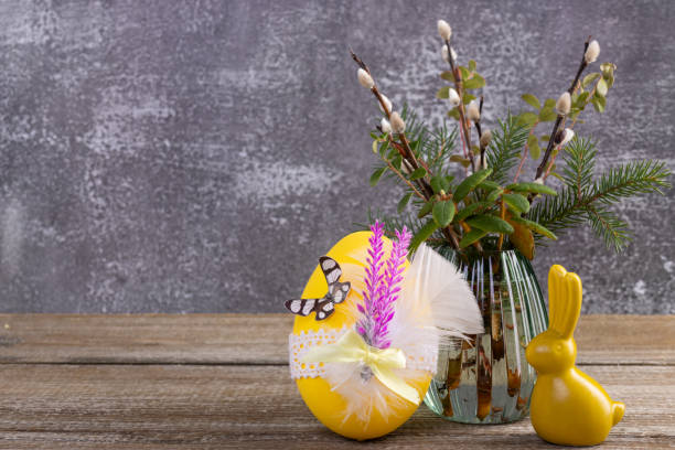istock Wooden table with Easter bunny, egg and bunch of willow. 2084836148