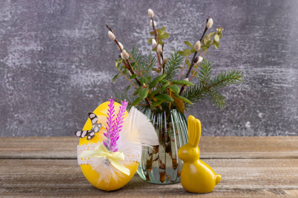 istock Wooden table with Easter bunny, egg and bunch of willow. 2084836150