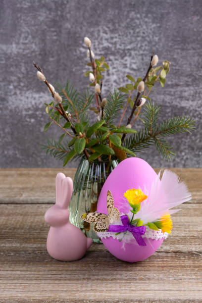 istock Wooden table with Easter bunny, egg and bunch of willow. 2084836672