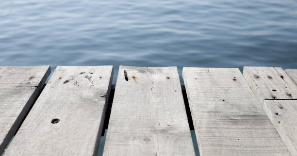 istock Wooden boardwalk with blue sea 2084838225