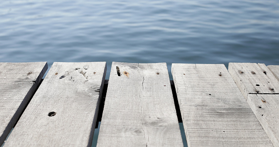 Wooden boardwalk with blue sea