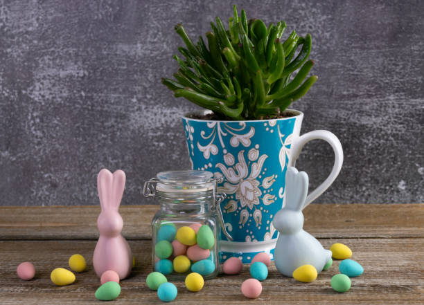 istock Cup with succulent, jar with Easter candies and bunny figurines. 2084838747