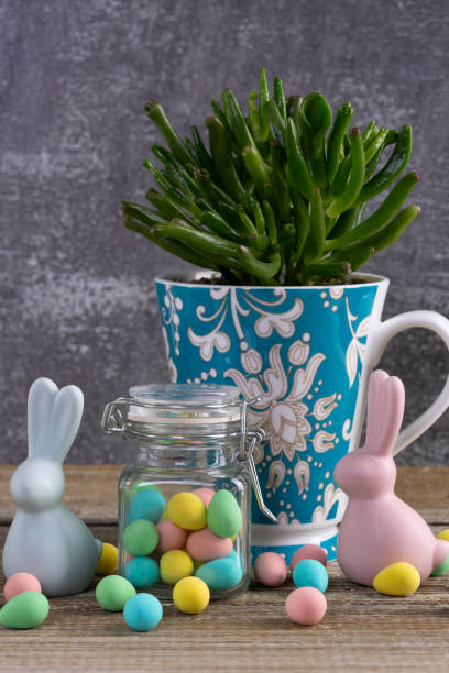 istock Cup with succulent, jar with Easter candies and bunny figurines. 2084838757
