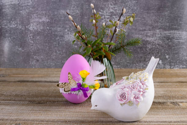 istock Easter decorated egg, pussywillow and a figurine of bird on the table. 2084839849