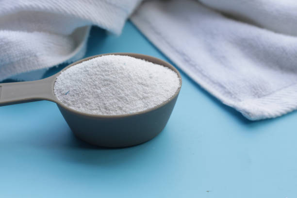 istock Detergent powder in measuring spoon with towel. Laundry concept. 2084841860