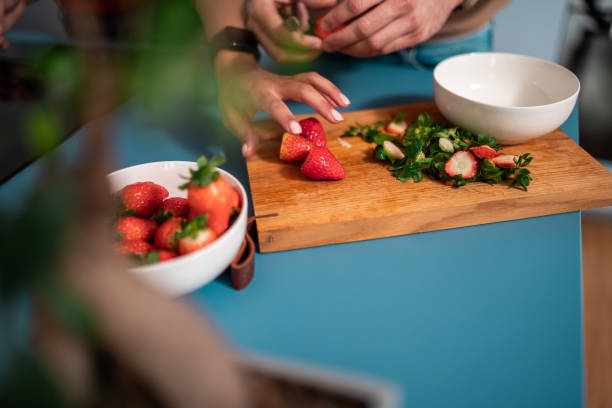 istock Hispanic Couple Preparing Fresh Salad at Home 2084854539
