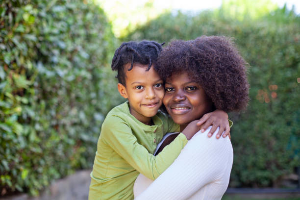 istock Spring portrait African mother embracing her child in backyard 2084855742