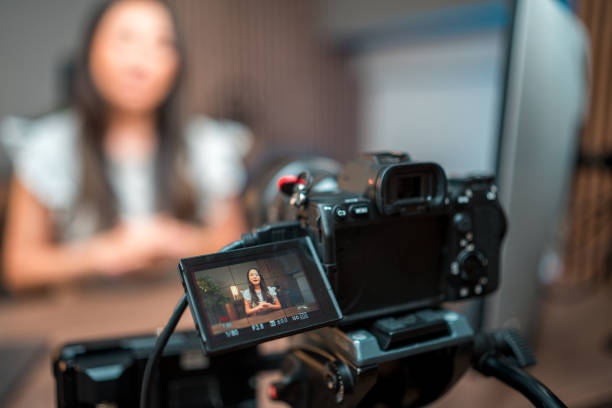 istock Behind the Camera View On Focused Asian Female Content Creator 2084864638