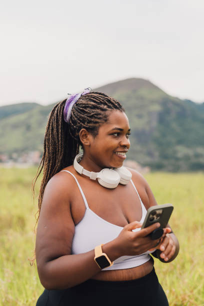 istock Plus size woman using smartphone on walk outdoors 2084881183