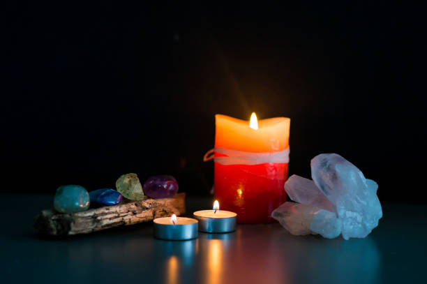 different stones and quartz together with lighted candles and candlesticks are used for relaxation therapies.