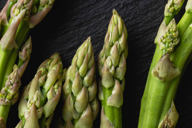 istock Green asparagus on a black background with copy space 2084901342