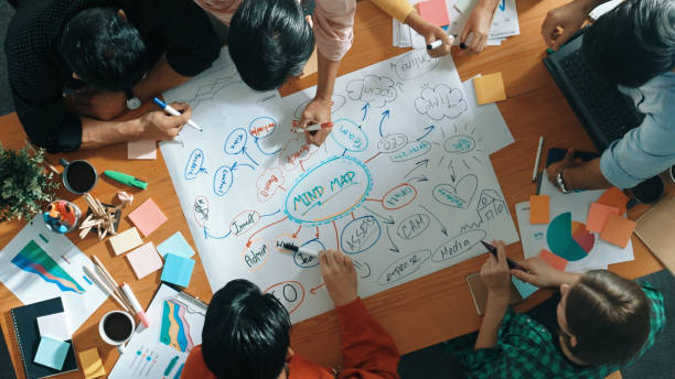 istock Group of business people writing and making mind map at meeting. Convocation. 2084906547