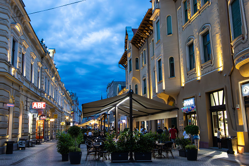 Oradea, Romania. July, 13, 2023. Calea Republicii (Republicii Street), a pedestrian street with art nouveau buildings, cafes and shops at night in the center of Oradea City