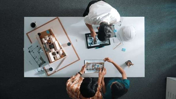 istock Top view of engineer looking tablet and planning building design. Alimentation. 2084938289