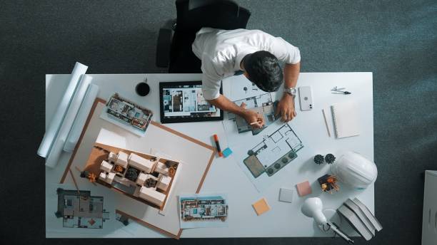 istock Top view of smart business man using tablet planning house design. Alimentation. 2084945573